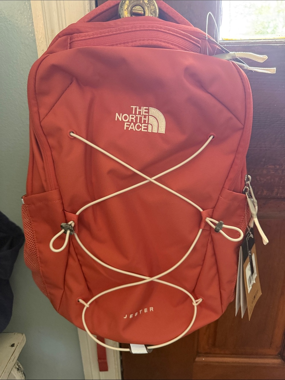 The North Face Jester Backpack in brick red with white bungee
